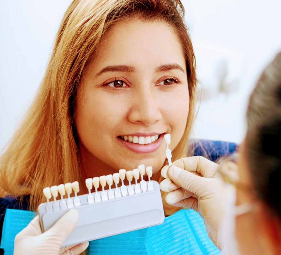 Patient viewing a tooth shade comparison during a dental consultation